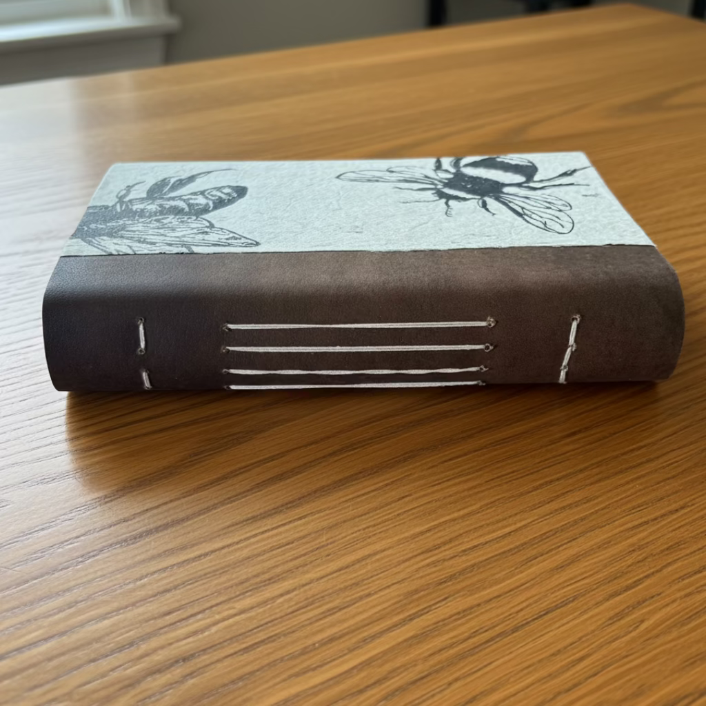 Book with black and white illustrations on a wooden surface